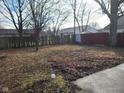 Large backyard with mature trees and wooden fence at 1908 Edgemont Way, Anderson, IN 46011