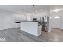 Modern kitchen featuring white cabinets, stainless steel appliances, and a breakfast bar at 20 Lancaster Ct, Trafalgar, IN 46181