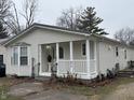 Beige house with white porch and bay window at 2413 N Milton St, Muncie, IN 47303