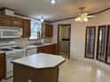 Kitchen with island and oak cabinets at 2413 N Milton St, Muncie, IN 47303