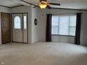 Spacious living room with bay window and ceiling fan at 2413 N Milton St, Muncie, IN 47303