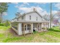 Two story home featuring a sunroom, back porch, and backyard at 310 Green St, Plainfield, IN 46168