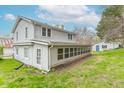 A cozy two-story home featuring a sunroom and adjacent garage at 310 Green St, Plainfield, IN 46168