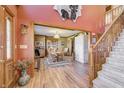 Grand entryway featuring wood floors, a staircase, and access to the formal dining room at 3101 E State Road 47, Lebanon, IN 46052