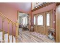 Home foyer boasting a wooden door, hardwood floors, and staircase leading to the upper level at 3101 E State Road 47, Lebanon, IN 46052