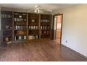 Inviting living room with hardwood floors, custom built-in bookshelves, and a ceiling fan at 3301 Timberbrook Ct, Danville, IN 46122