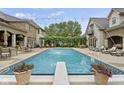 Beautiful in-ground pool with diving board, patio furniture, and meticulously manicured landscaping at 5030 Nightshade Ln, Noblesville, IN 46062