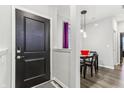 Bright entryway with dark door, purple curtain, and small dining area at 6433 Wasco Dr, Whitestown, IN 46075