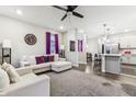 Spacious living room with L-shaped sofa, ceiling fan, and open floor plan at 6433 Wasco Dr, Whitestown, IN 46075