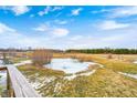 Frozen pond and open fields with a wooden deck in the foreground at 7615 Fayette Rd, Lebanon, IN 46052