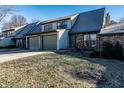 Townhouse with a two-car garage and a well-maintained lawn and landscaping at 788 Monte Vista Ct, Greenwood, IN 46143
