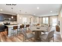 Open concept kitchen and dining area with modern appliances and island at 10349 Gateway Dr, Brownsburg, IN 46234