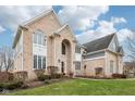 Beautiful brick home featuring elegant architectural design and well-maintained grounds at 11106 Muirfield Trce, Fishers, IN 46037