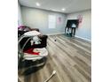 Bright living room with wood-look floors and a TV at 1243 W 19Th St, Indianapolis, IN 46202