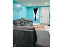 Living room with gray sectional sofa and teal walls at 3128 S Holt Rd, Indianapolis, IN 46221