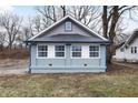 Newly renovated home with gray siding, blue accents and a landscaped yard at 3340 N Sherman Dr, Indianapolis, IN 46218