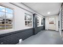 Enclosed front porch with brick columns and new flooring at 3340 N Sherman Dr, Indianapolis, IN 46218