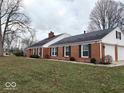 Side view of a brick ranch house with a two-car garage at 3618 N Royal Oak Dr, Muncie, IN 47304