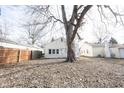 View of the backyard featuring a wooden fence and mature trees at 4034 N Temple Ave, Indianapolis, IN 46205