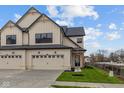Beautiful townhome boasts a two-car garage and a well-maintained lawn at 4171 Douro Trl, Westfield, IN 46062