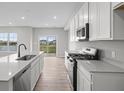 Bright, eat-in kitchen featuring quartz countertops, stainless appliances, and a sliding glass door at 4195 Douro Trl, Westfield, IN 46062
