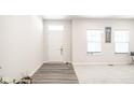 Bright entryway with gray vinyl plank flooring and neutral walls at 453 Gathering Ln, Greenwood, IN 46143
