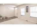 Living room featuring neutral walls, carpeting, and vinyl plank flooring at 453 Gathering Ln, Greenwood, IN 46143