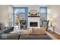 Bright living room with fireplace, modern furnishings, and large windows offering plenty of natural light at 6412 Bay Vista Ct, Indianapolis, IN 46250