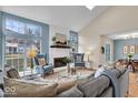 Open living space with vaulted ceilings, fireplace, and expansive windows offering an abundance of light at 6412 Bay Vista Ct, Indianapolis, IN 46250