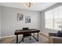 Bright home office with a large window, desk, and comfortable chair at 6559 Seabiscuit Rd, Whitestown, IN 46075