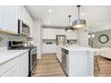 Modern kitchen with white cabinets, stainless steel appliances, and an island at 7150 Firestone Rd, Whitestown, IN 46052