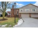 Two-story townhouse with brick and siding exterior, attached garage, and landscaping at 7564 Farm View E Cir, Indianapolis, IN 46256