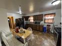 Kitchen with wood cabinets, tiled floor, and stainless steel appliances at 100 S Manhattan Ave, Muncie, IN 47303