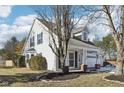Two-story house with a light beige exterior, white garage door, and landscaped yard at 10322 Sage Ct, Noblesville, IN 46060