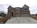 Beautiful two-story brick home featuring a three-car garage, offering a blend of style and functionality at 1144 Ridgevine Rd, Greenwood, IN 46143