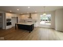 Modern kitchen with a large center island, white cabinetry, stainless steel appliances, and ample counter space at 1144 Ridgevine Rd, Greenwood, IN 46143