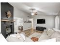 Bright living area featuring a brick fireplace, hardwood floors, and a comfortable seating arrangement at 12301 Van Spronsen Ct, Indianapolis, IN 46236