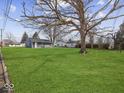Large backyard with a detached garage and mature trees at 403 Wellington Blvd, Shelbyville, IN 46176