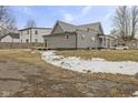 Exterior view of a gray home featuring a small deck off the back entrance at 429 Wood St, Greenfield, IN 46140
