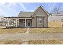 Inviting gray home featuring a covered porch with white columns and gray trim at 429 Wood St, Greenfield, IN 46140