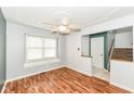 Cozy living room boasting hardwood floors, a large window, and view of the staircase and entryway at 493 Clearwater Blvd, Whiteland, IN 46184