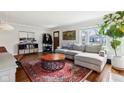 Light-filled living room featuring hardwood floors, sectional sofa, and a coffee table at 5449 Indianola Ave, Indianapolis, IN 46220