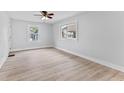 Bright bedroom featuring light wood floors, and two large windows at 55 E Regent St, Indianapolis, IN 46225