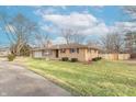 Brick ranch house with a spacious lawn and driveway at 6149 Winnpeny Ln, Indianapolis, IN 46220