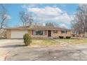 Front view of a ranch house with a brick facade and mature trees at 6149 Winnpeny Ln, Indianapolis, IN 46220