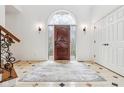 Elegant foyer featuring a decorative front door and a neutral rug with a detailed tile border at 6437 N Oxbow Way, Indianapolis, IN 46220