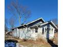 Side view of a light blue bungalow with visible yard and tree at 710 N Drexel Ave, Indianapolis, IN 46201