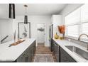 Modern kitchen with dark cabinetry, quartz countertops, and stainless steel appliances at 9891 Sunbranch Dr, Carmel, IN 46290