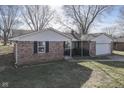 Ranch house with brick facade, attached garage, and yard at 105 Kenova Dr, Indianapolis, IN 46227