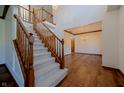 Inviting foyer with a grand staircase, hardwood floors, and chandelier at 10823 Knightsbridge Ln, Fishers, IN 46037